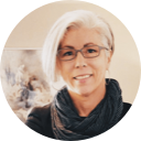 A smiling woman with short blonde hair